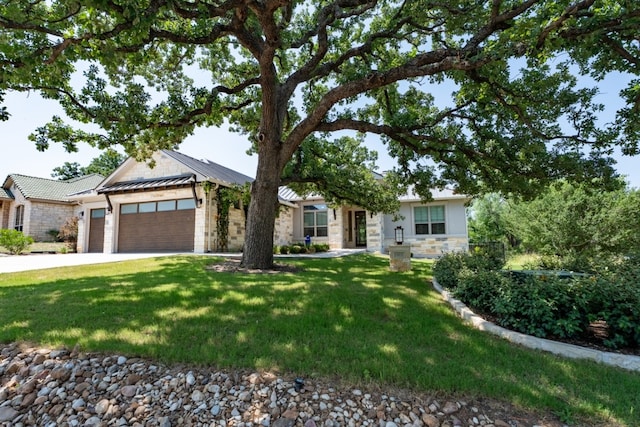503 Fire Dance, Horseshoe Bay, TX 78657 - view of front of house featuring an attached garage, stone siding, a front lawn, and driveway