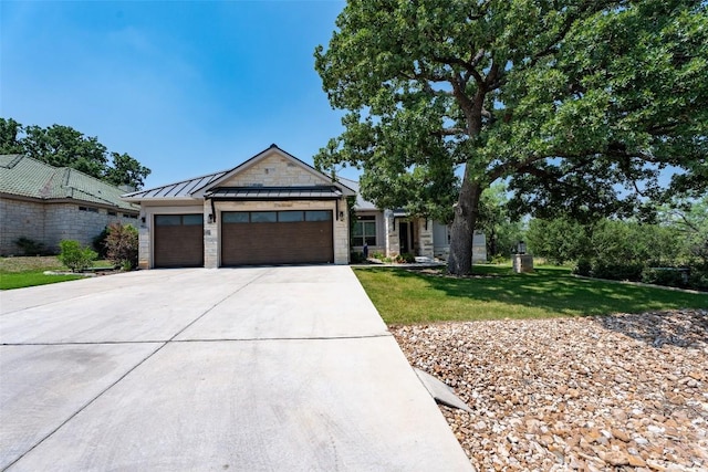 503 Fire Dance, Horseshoe Bay, TX 78657 - view of front of home featuring an attached garage, driveway, a front yard, a standing seam roof, and metal roof