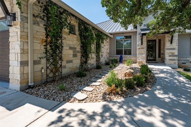 503 Fire Dance, Horseshoe Bay, TX 78657 - doorway to property featuring stone siding, a standing seam roof, metal roof, and an attached garage