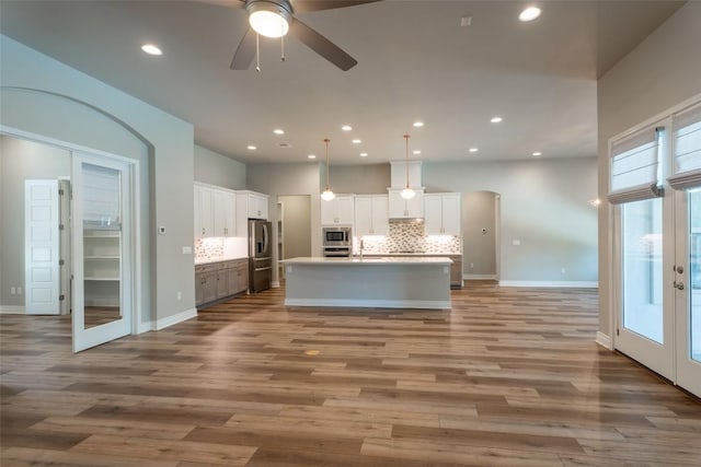 503 Fire Dance, Horseshoe Bay, TX 78657 - kitchen featuring stainless steel appliances, ceiling fan, french doors, open floor plan, and wood finished floors