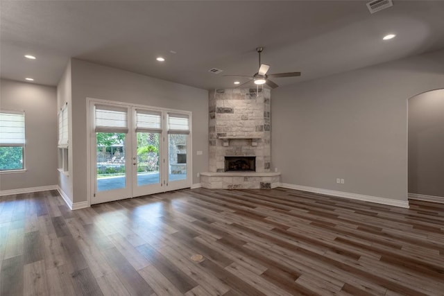 503 Fire Dance, Horseshoe Bay, TX 78657 - unfurnished living room with ceiling fan, wood finished floors, baseboards, recessed lighting, and arched walkways