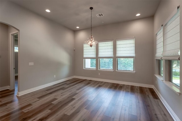 503 Fire Dance, Horseshoe Bay, TX 78657 - unfurnished dining area featuring plenty of natural light, arched walkways, dark wood finished floors, a chandelier, and recessed lighting