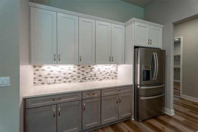 503 Fire Dance, Horseshoe Bay, TX 78657 - kitchen featuring stainless steel refrigerator with ice dispenser, backsplash, light countertops, and dark wood-style flooring