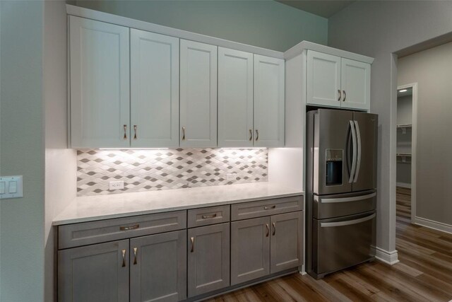 503 Fire Dance, Horseshoe Bay, TX 78657 - kitchen featuring stainless steel fridge with ice dispenser, backsplash, dark wood-style floors, and light countertops