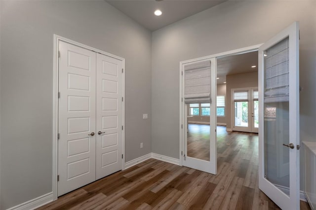 503 Fire Dance, Horseshoe Bay, TX 78657 - unfurnished room featuring french doors, wood finished floors, baseboards, and recessed lighting