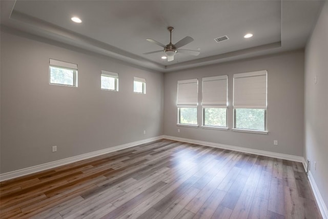 503 Fire Dance, Horseshoe Bay, TX 78657 - spare room with a raised ceiling, ceiling fan, wood finished floors, baseboards, and recessed lighting
