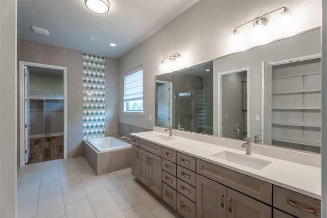 503 Fire Dance, Horseshoe Bay, TX 78657 - bathroom with a bath, double vanity, a stall shower, a walk in closet, and tile patterned flooring