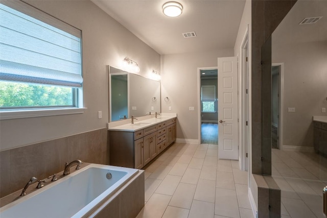 503 Fire Dance, Horseshoe Bay, TX 78657 - full bath featuring double vanity, a bath, tile patterned flooring, and baseboards