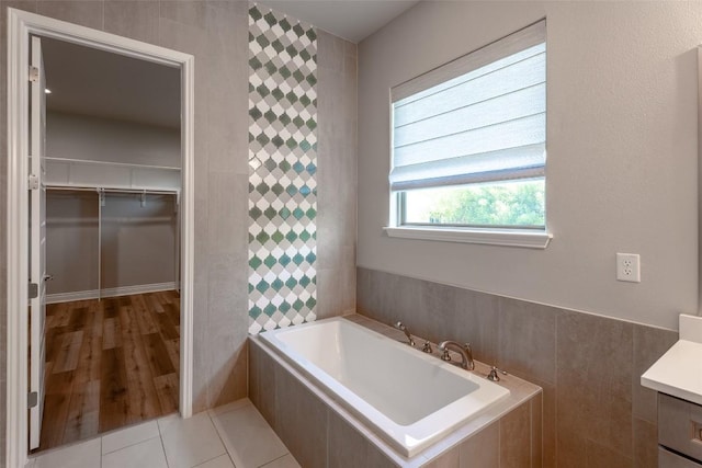 503 Fire Dance, Horseshoe Bay, TX 78657 - bathroom featuring a bath, vanity, and a walk in closet