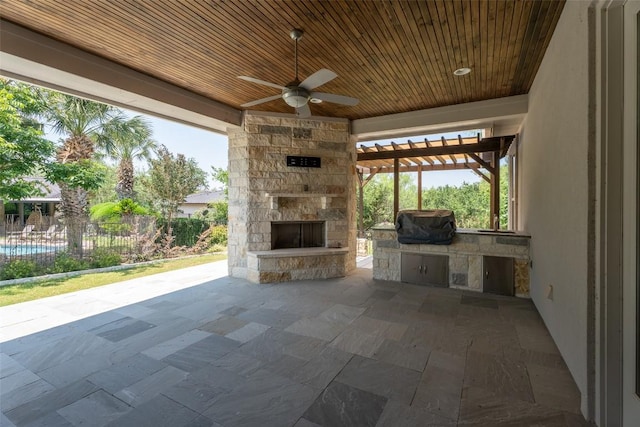 503 Fire Dance, Horseshoe Bay, TX 78657 - view of patio with area for grilling, a ceiling fan, and an outdoor stone fireplace