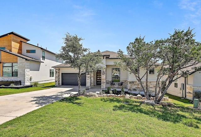 6801 Liberty Grotto Ct, Jonestown, TX 78645 - view of front facade with an attached garage, driveway, a front lawn, stucco siding, and stone siding