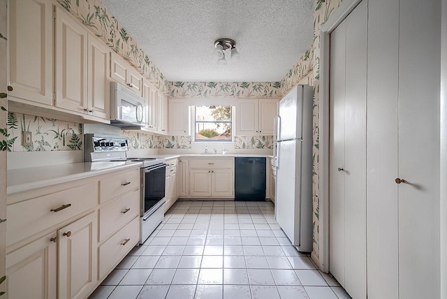 428 Summit Cir, Fredericksburg, TX 78624 - kitchen featuring white appliances, light countertops, a textured ceiling, wallpapered walls, and light tile patterned flooring