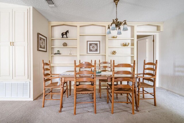 428 Summit Cir, Fredericksburg, TX 78624 - dining space with light carpet, a chandelier, a textured ceiling, and baseboards