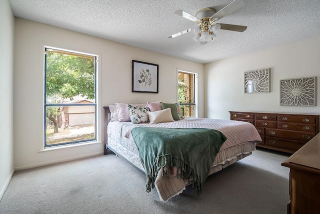 428 Summit Cir, Fredericksburg, TX 78624 - bedroom with carpet, a textured ceiling, and a ceiling fan