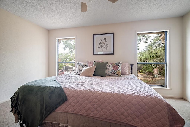 428 Summit Cir, Fredericksburg, TX 78624 - bedroom with carpet flooring, baseboards, a ceiling fan, and a textured ceiling