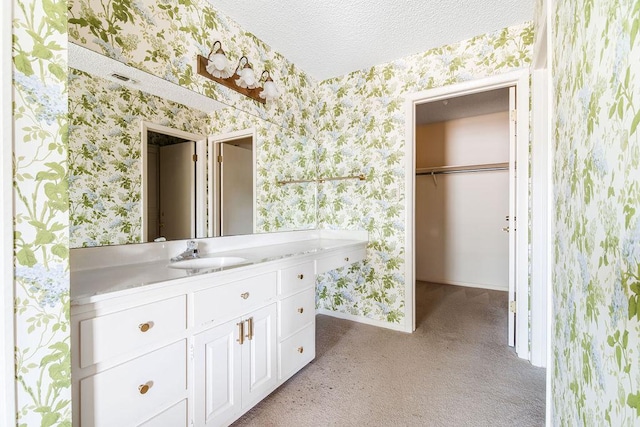 428 Summit Cir, Fredericksburg, TX 78624 - bathroom featuring wallpapered walls, baseboards, vanity, and a textured ceiling