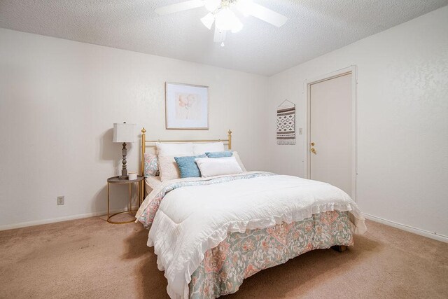 428 Summit Cir, Fredericksburg, TX 78624 - bedroom with carpet floors, a textured ceiling, a ceiling fan, and baseboards