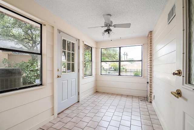 428 Summit Cir, Fredericksburg, TX 78624 - unfurnished sunroom with a textured ceiling and wood walls