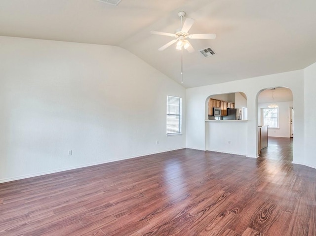 581 Sampson, Kyle, TX 78640 - unfurnished living room with a ceiling fan, arched walkways, lofted ceiling, dark wood-style floors, and baseboards