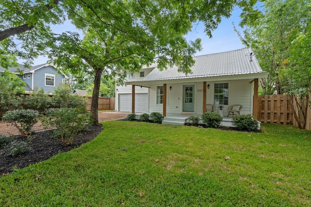 1607 Forest St, Georgetown, TX 78626 - view of front of house with a porch, a garage, metal roof, and driveway