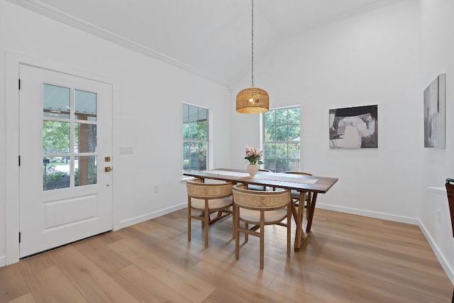 1607 Forest St, Georgetown, TX 78626 - dining room featuring crown molding, light wood finished floors, baseboards, and vaulted ceiling