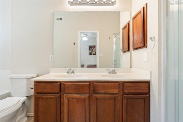 3005 Sugar Berry Cv, Round Rock, TX 78664 - bathroom with double vanity, an enclosed shower, toilet, and a ceiling fan