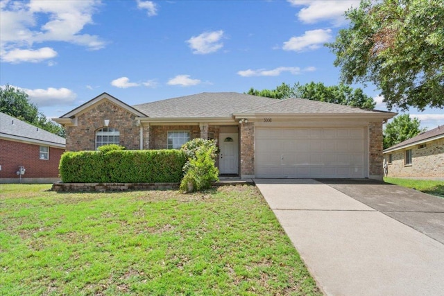 3005 Sugar Berry Cv, Round Rock, TX 78664 - ranch-style home with an attached garage, a front yard, driveway, and brick siding