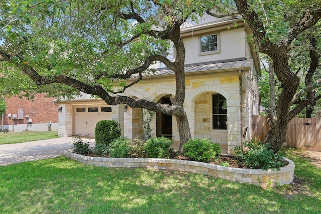12109 Bryony Dr, Austin, TX 78739 - view of front of property with stone siding, concrete driveway, a standing seam roof, a garage, and metal roof