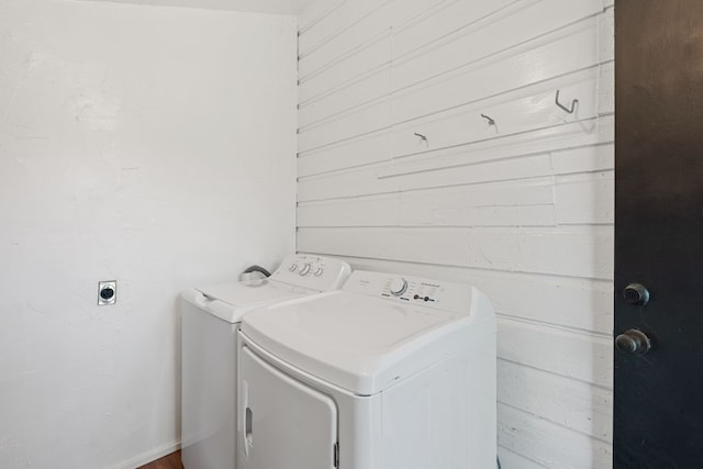 1303 Walnut Ave, Austin, TX 78702 - washroom featuring washer and dryer and wooden walls