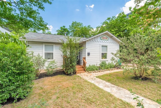 1303 Walnut Ave, Austin, TX 78702 - view of front of home featuring a front lawn and board and batten siding