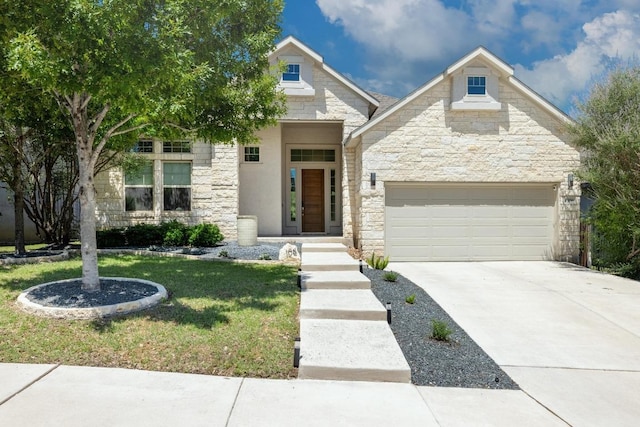 108 Panzano Dr, Georgetown, TX 78628 - view of front facade with stone siding, concrete driveway, a front yard, and an attached garage
