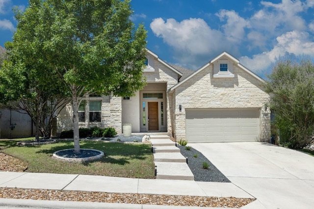 108 Panzano Dr, Georgetown, TX 78628 - view of front of property with stone siding, driveway, a garage, and a front yard