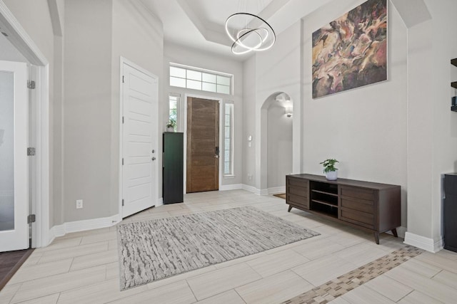 108 Panzano Dr, Georgetown, TX 78628 - foyer entrance with arched walkways, a high ceiling, and a chandelier