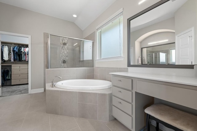 108 Panzano Dr, Georgetown, TX 78628 - bathroom featuring a garden tub, a shower stall, vanity, tile patterned flooring, and vaulted ceiling