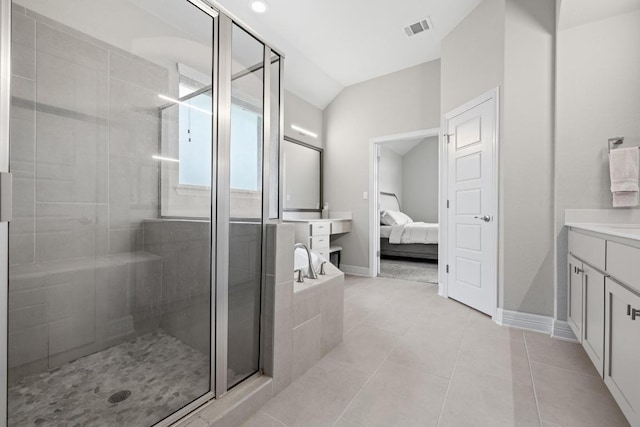108 Panzano Dr, Georgetown, TX 78628 - full bathroom featuring vanity, ensuite bathroom, a shower stall, lofted ceiling, and tile patterned flooring