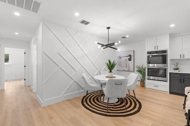 813 Cardiff Dr, Austin, TX 78745 - dining area featuring a decorative wall, light wood finished floors, recessed lighting, a chandelier, and baseboards