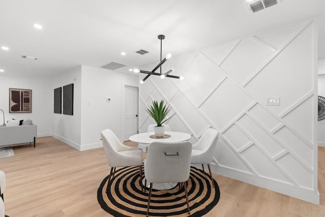 813 Cardiff Dr, Austin, TX 78745 - dining room with light wood-style floors, recessed lighting, and a decorative wall