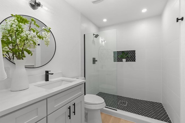 813 Cardiff Dr, Austin, TX 78745 - full bath with vanity, walk in shower, recessed lighting, and wood finished floors