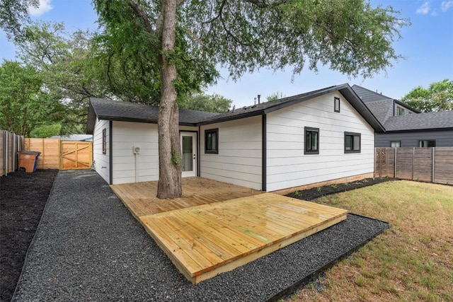813 Cardiff Dr, Austin, TX 78745 - back of property featuring a fenced backyard, a wooden deck, and a gate
