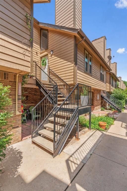 5608 Cougar Dr Unit 226, Austin, TX 78745 - view of exterior entry featuring a patio and a chimney