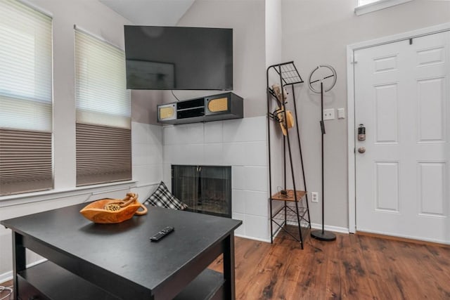 5608 Cougar Dr Unit 226, Austin, TX 78745 - living room with wood finished floors, a fireplace, baseboards, and vaulted ceiling