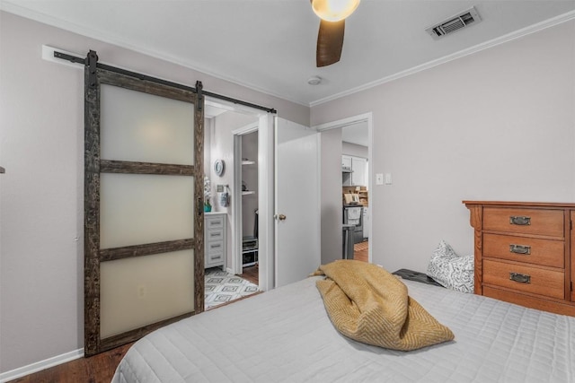 5608 Cougar Dr Unit 226, Austin, TX 78745 - bedroom with a barn door, wood finished floors, ornamental molding, a ceiling fan, and baseboards