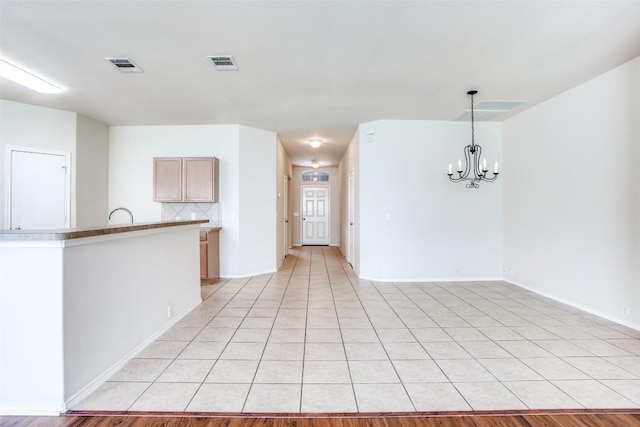612 Arrowood Pl, Round Rock, TX 78665 - spare room with a chandelier, light tile patterned flooring, and baseboards