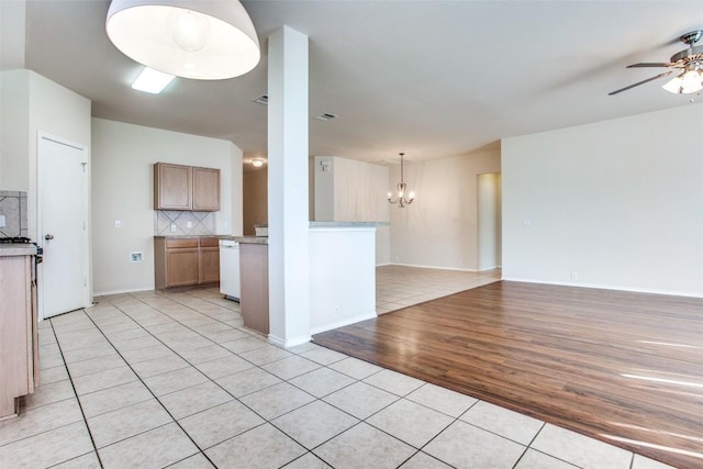 612 Arrowood Pl, Round Rock, TX 78665 - kitchen with open floor plan, light tile patterned floors, a ceiling fan, white dishwasher, and tasteful backsplash