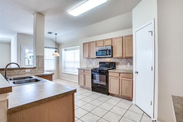 612 Arrowood Pl, Round Rock, TX 78665 - kitchen with black range with gas cooktop, stainless steel microwave, a sink, decorative backsplash, and lofted ceiling
