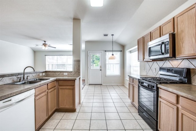 612 Arrowood Pl, Round Rock, TX 78665 - kitchen featuring stainless steel microwave, white dishwasher, black range with gas cooktop, a sink, and backsplash