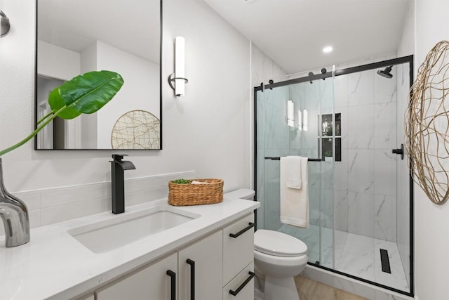 903 Cardiff Dr, Austin, TX 78745 - full bathroom with toilet, vanity, a marble finish shower, and recessed lighting