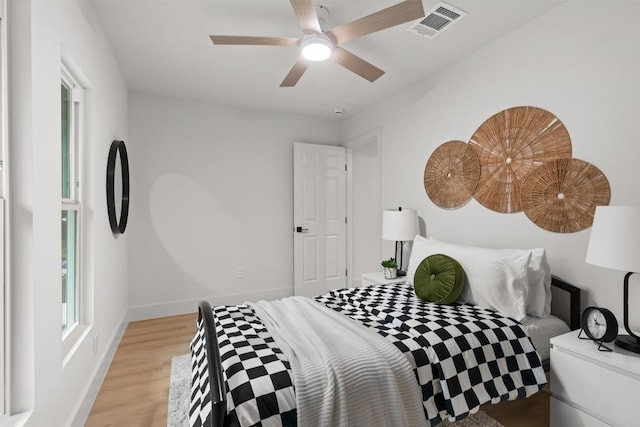 903 Cardiff Dr, Austin, TX 78745 - bedroom with light wood-style flooring, baseboards, and a ceiling fan