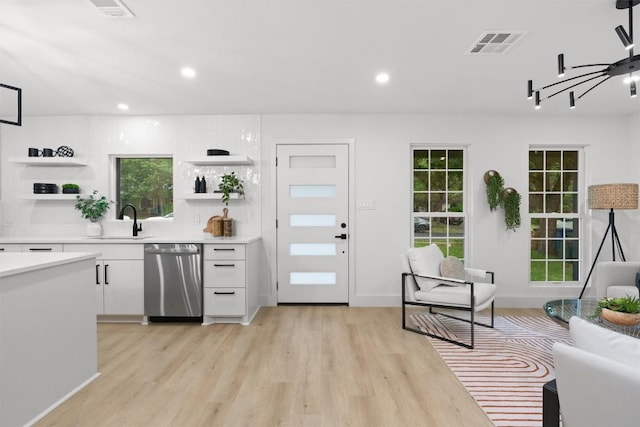 903 Cardiff Dr, Austin, TX 78745 - kitchen featuring dishwasher, open shelves, a sink, white cabinets, and light countertops
