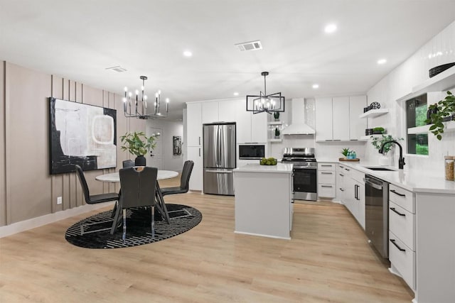 903 Cardiff Dr, Austin, TX 78745 - kitchen featuring stainless steel appliances, a chandelier, open shelves, wall chimney range hood, and recessed lighting